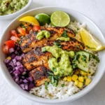 A finished Blackened Fish Taco Bowl with avocado and lime sauce