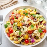 Fresh Mediterranean Pasta Salad in a white bowl on a wooden table
