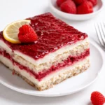 Fresh Raspberry Tiramisu in a glass baking dish with fresh fruit garnish