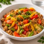 A colorful skillet of ground turkey and bell peppers with lime.