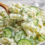 A bowl of creamy Healthy Cucumber Pasta Salad with fresh dill.