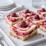 Lemon Raspberry Swirl Bars stacked on a white plate