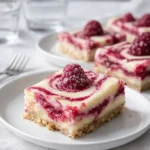 A stack of delicious Lemon Raspberry Swirl Bars with fresh fruit.