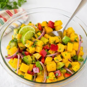 Fresh Mango Salad Recipe with avocado and red bell pepper in a white bowl.