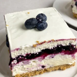 No-Bake Blueberry Cheesecake Bars layered on a platter