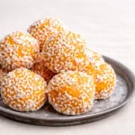 3-Ingredient Apricot Coconut Balls stacked on a blue plate