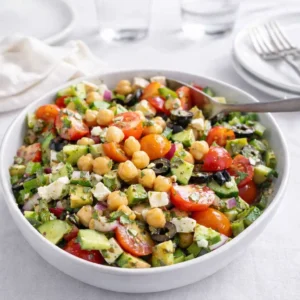 Fresh Mediterranean Chickpea Salad with feta and avocado in a white bowl
