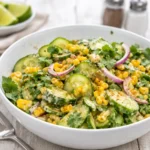 A colorful bowl of fresh Mexican Cucumber Salad with corn and lime dressing.